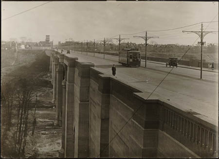 Historic photo from 1922 - Danforth Viaduct 1922 - man, trolly, and car in Don River