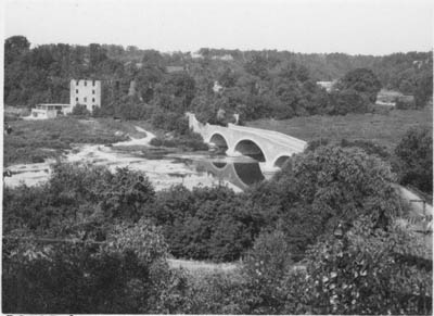 Historic photo from Sunday, July 27, 1930 - Old mill and bridge over the Humber River - concrete arch bridge with a stone facing designed by Frank Barber and built 1916  in Kingsway