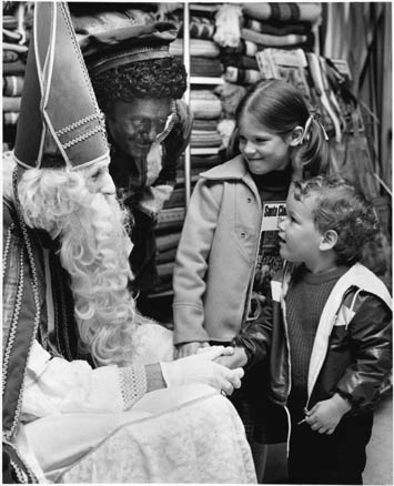 A Dutch Santa Claus greeting children