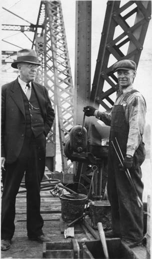 A Canadian National Railway conductor and Canadian National Railway worker at work