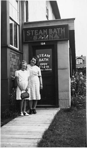 A girl and a woman standing in from of a Steam Bath