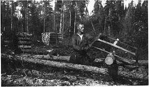 Oskar Kojonen using a hand saw in lumber camp in Shillington