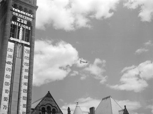 Historic photo from 1945 - Toronto built Mosquito bomber in the air over Toronto City Hall  in City Hall