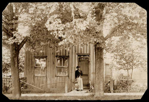 Miss Clarice Brantford in front of the old Brantford home on Brock Street, Amherstburg