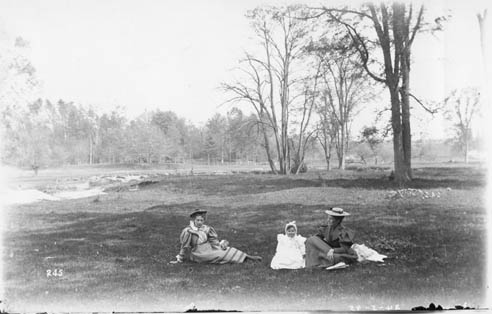 Historic photo from 1896 - Down where the violets grow - Two women and a child seated in the Black Creek, Weston in Keelesdale