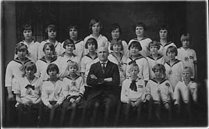 Finnish Canadian Voima girls gymnastic group with director Jalmari Kauppi sitting in the centre