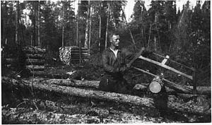 Oskar Kojonen using a hand saw in lumber camp in Shillington