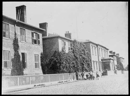 Historic photo from 1865 - Children outside the Upper Canada College buildings on King Street West in King Street West