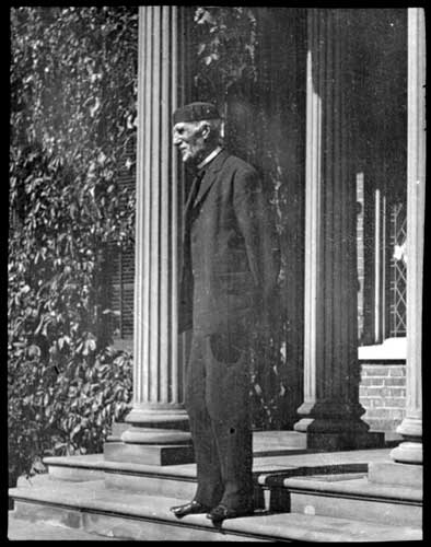 Historic photo from 1908 - Goldwyn Smith, standing in front of his home, the Grange, on Dundas Street West, Toronto in Art Gallery of Ontario